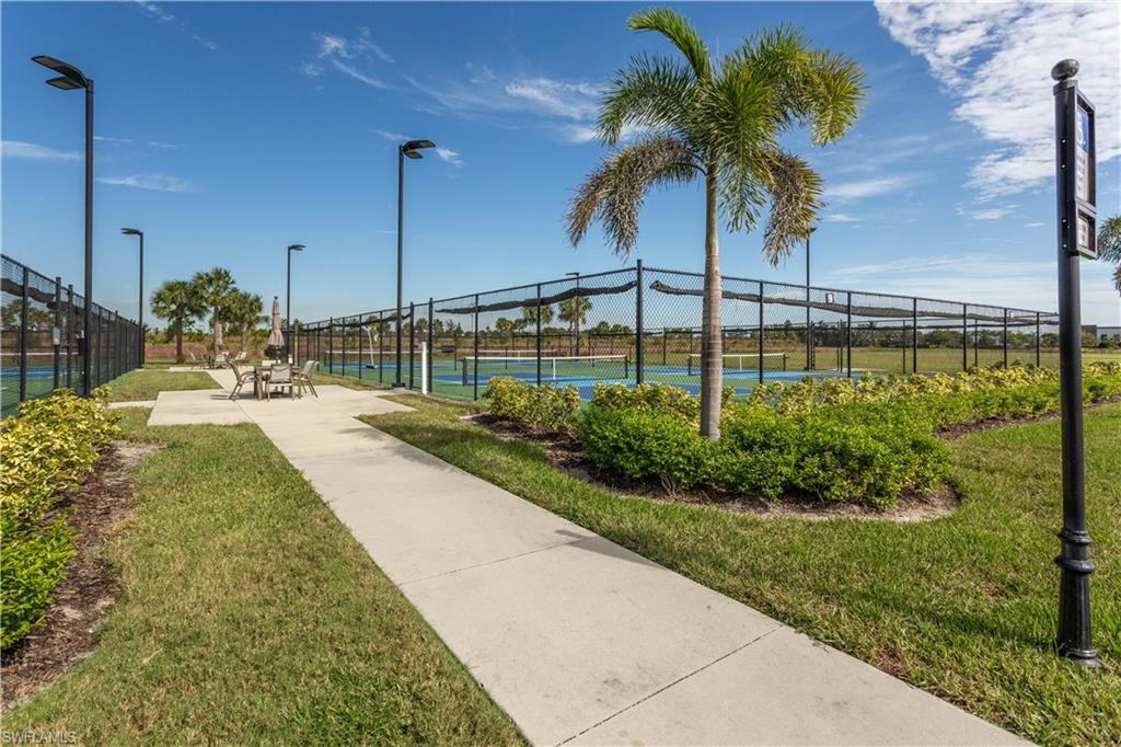 18293 Ridgeline Drive Estero, FL 33928 - Photo 32 of 47 a view of a swimming pool with a garden