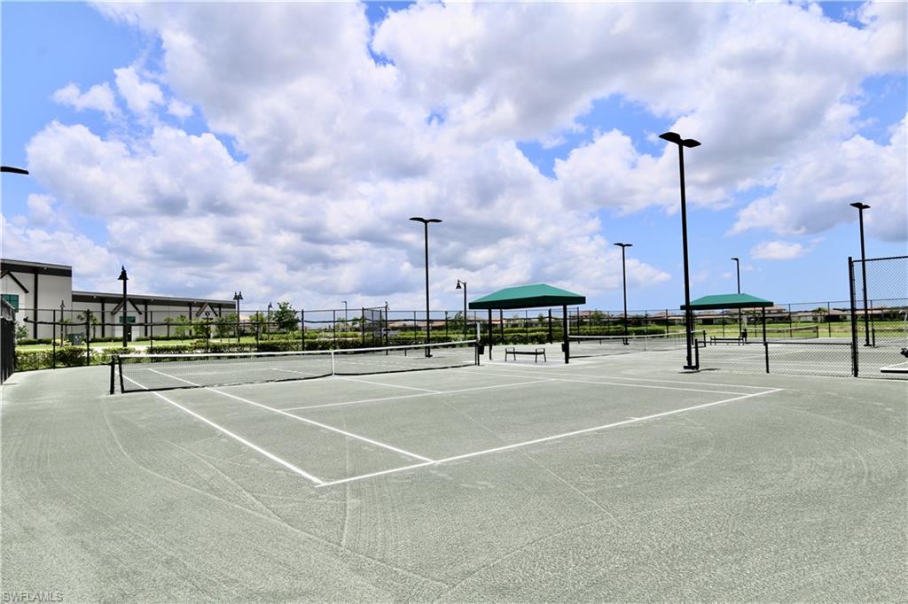 18293 Ridgeline Drive Estero, FL 33928 - Photo 34 of 47 a view of a tennis ground with big trees