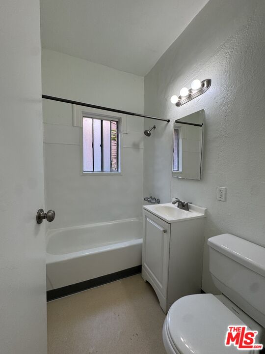 a bathroom with a sink a toilet a mirror and a bathtub