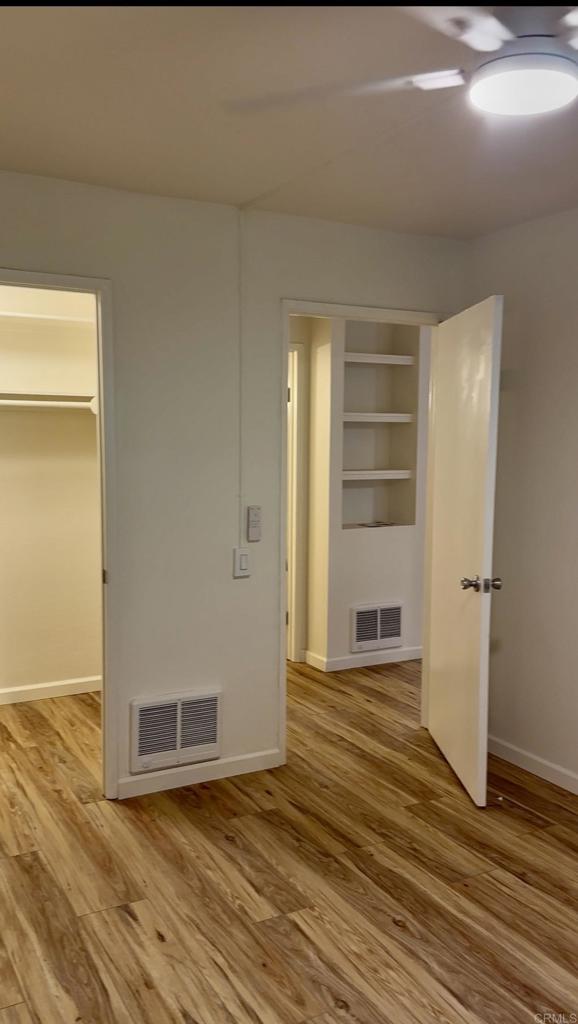6394 Rancho Mission Road San Diego, CA 92108 - Photo 5 of 14 a view of a room with wooden floor