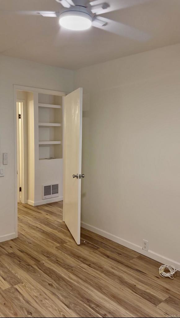 6394 Rancho Mission Road San Diego, CA 92108 - Photo 6 of 14 a view of an empty room with wooden floor and closet