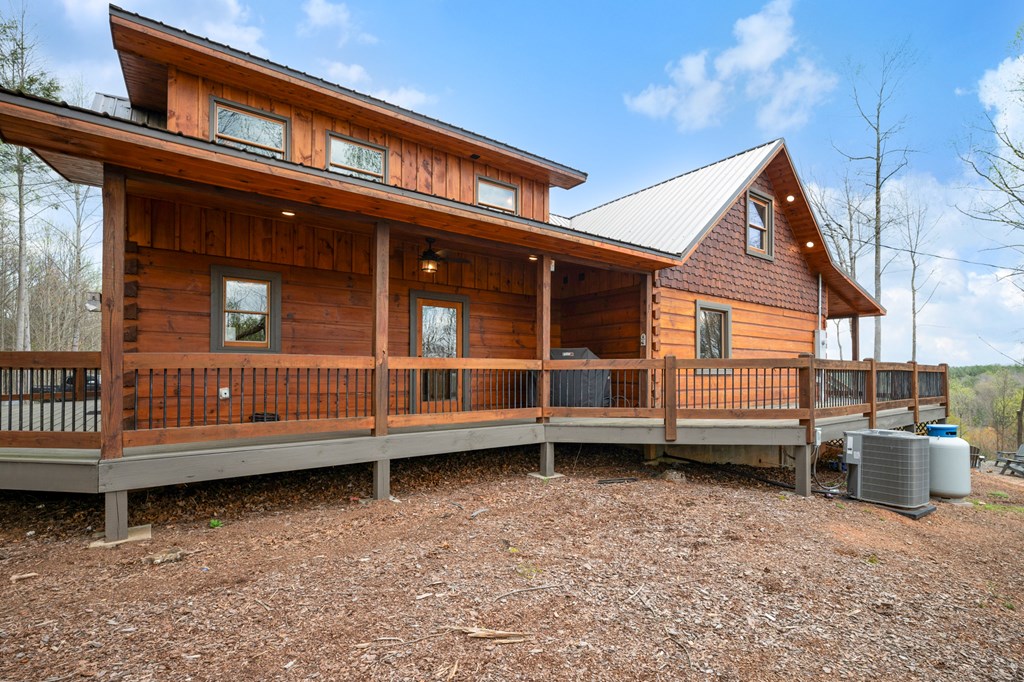 136 A Pack Creek Road Blue Ridge, GA 30513 - Photo 25 of 66 a view of a house with a wooden deck and a yard