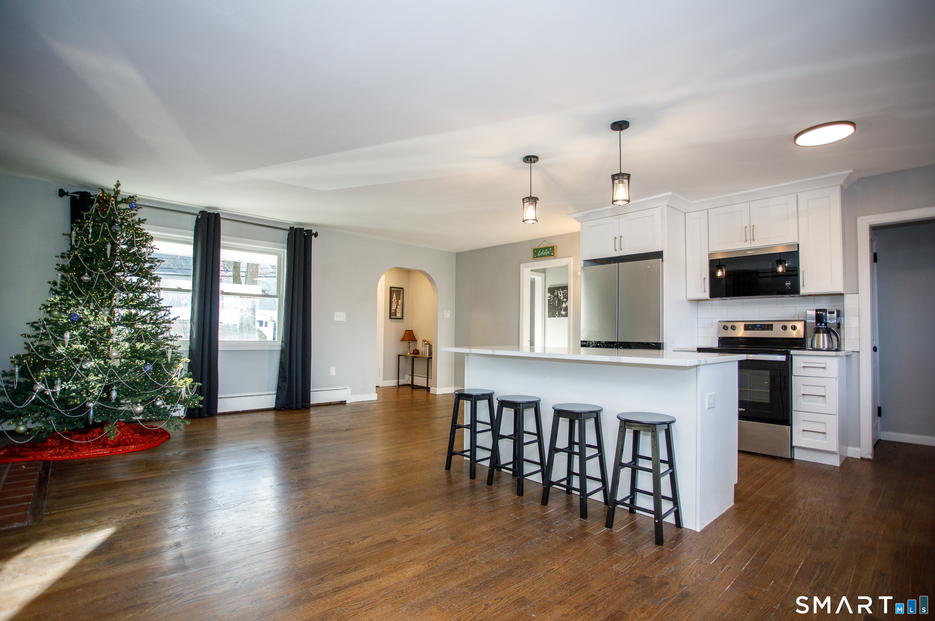 18 Richards Grove Road Waterford, CT 06375 - Photo 23 of 23 a kitchen with stainless steel appliances granite countertop a stove top oven a sink dishwasher a dining table and chairs with wooden floor