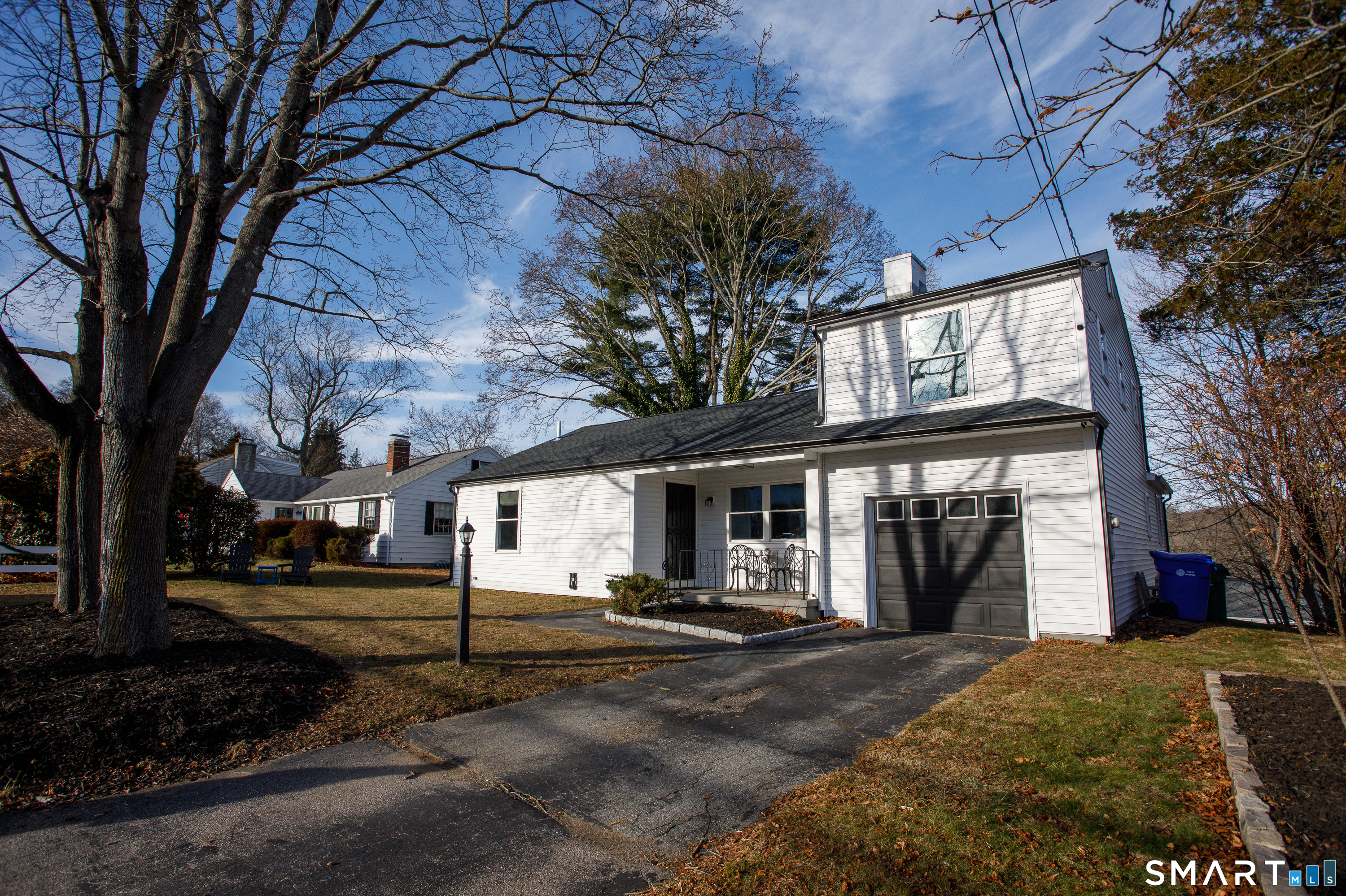 18 Richards Grove Road Waterford, CT 06375 - Photo 19 of 23 a view of a white house with a large tree