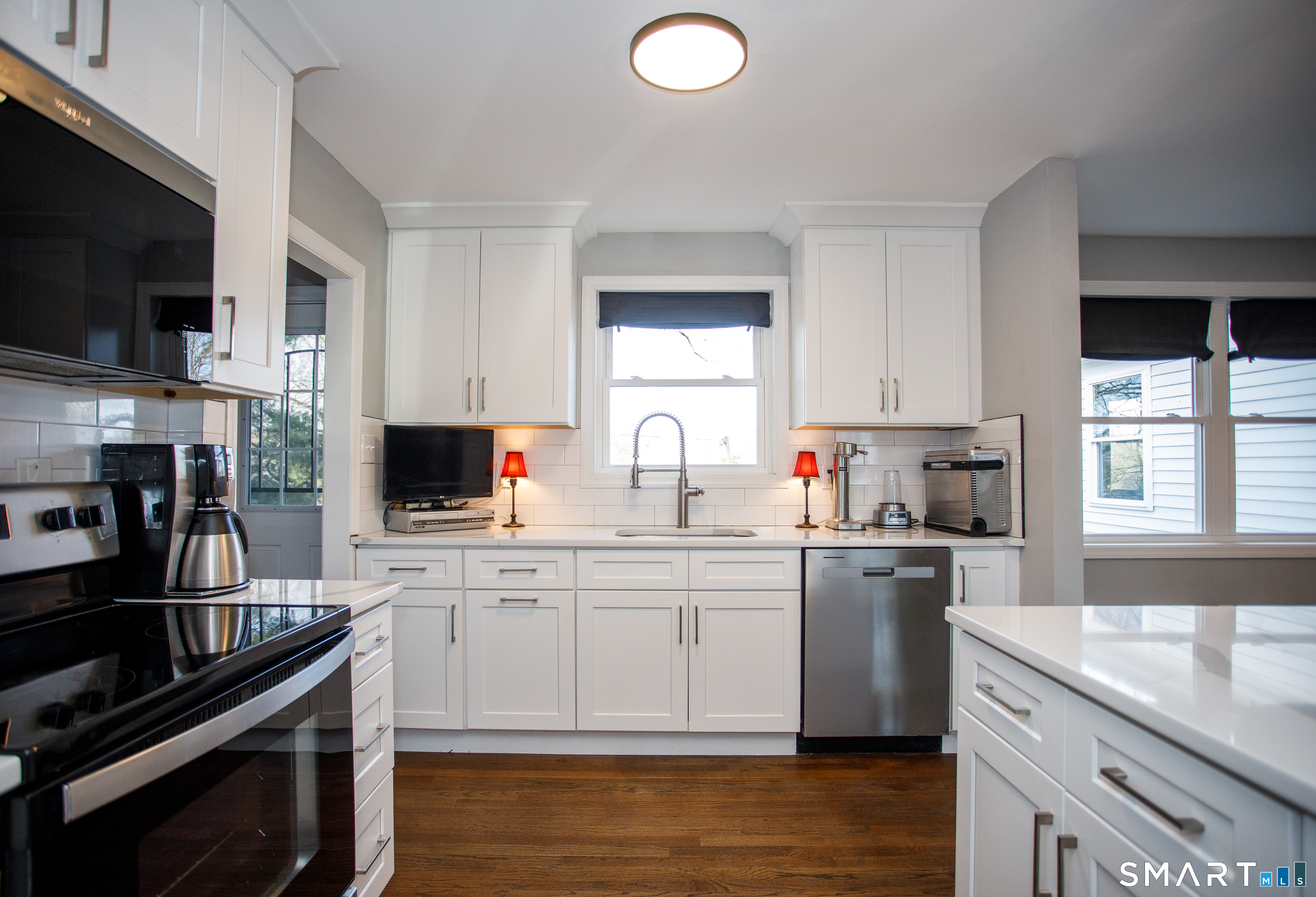 18 Richards Grove Road Waterford, CT 06375 - Photo 2 of 23 a kitchen with stainless steel appliances granite countertop a stove top oven a sink dishwasher and a microwave oven with cabinets