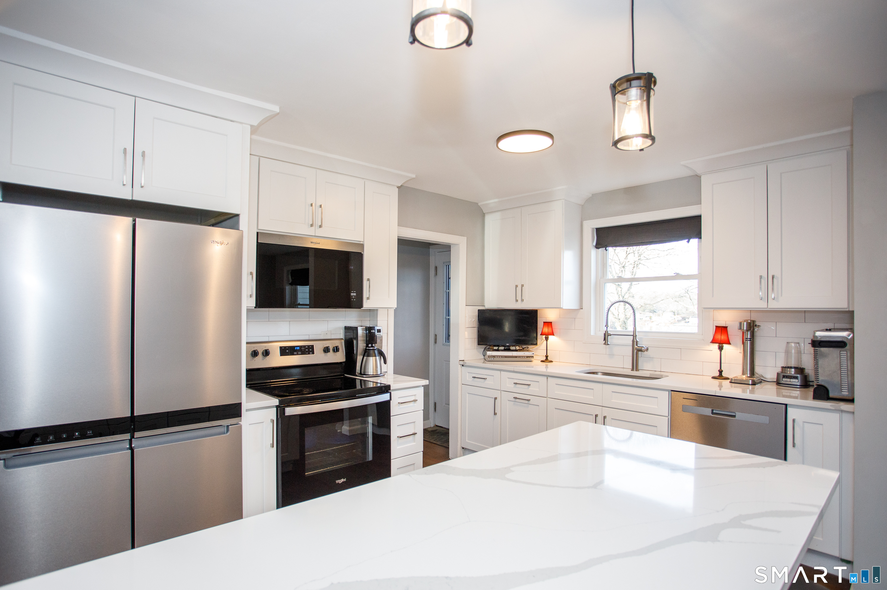 18 Richards Grove Road Waterford, CT 06375 - Photo 5 of 23 a kitchen with granite countertop a refrigerator a sink and white cabinets