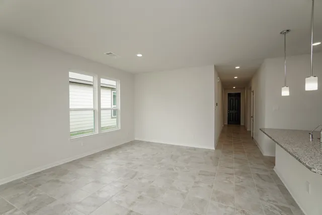 a view of kitchen with stainless steel appliances a refrigerator sink and microwave
