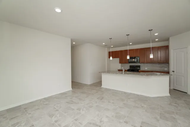a view of kitchen with stainless steel appliances a refrigerator and a microwave