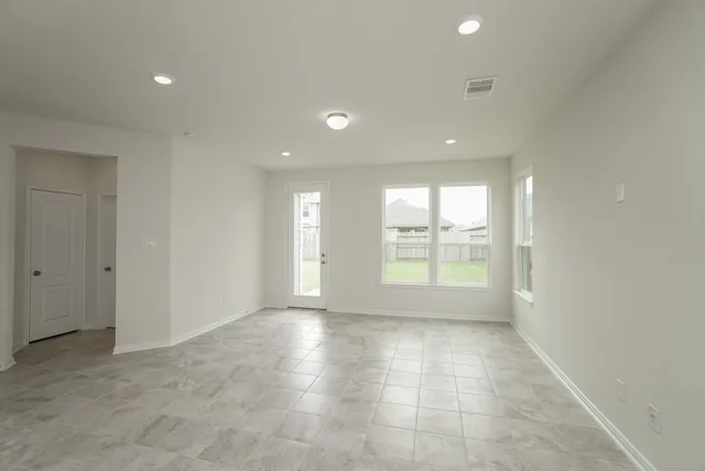 a view of kitchen with kitchen island and stainless steel appliances