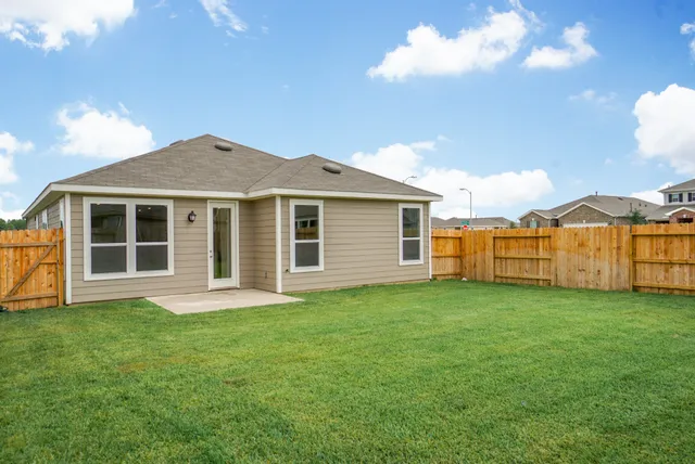 a view of a yard with a house in the background