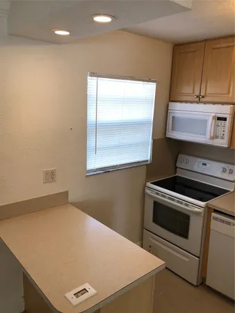 a kitchen with a stove and a microwave