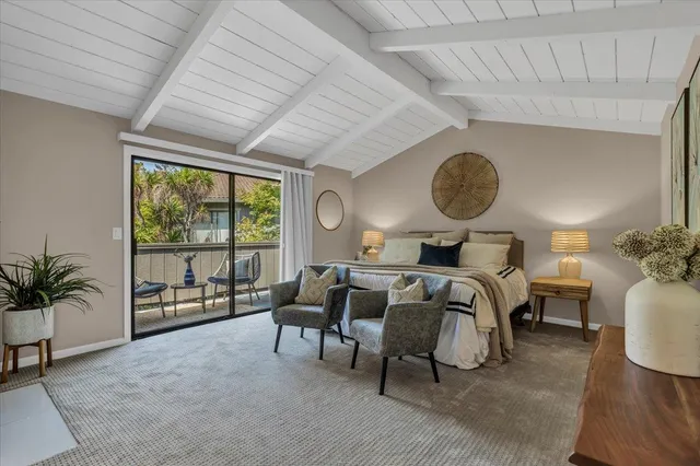 a bedroom with furniture and a large window