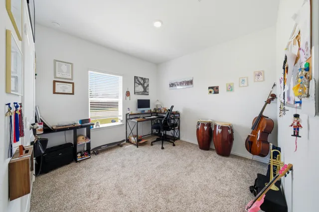a view of a workspace with furniture and a window