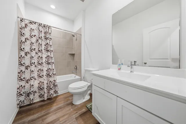 a bathroom with a sink toilet a shower and a mirror