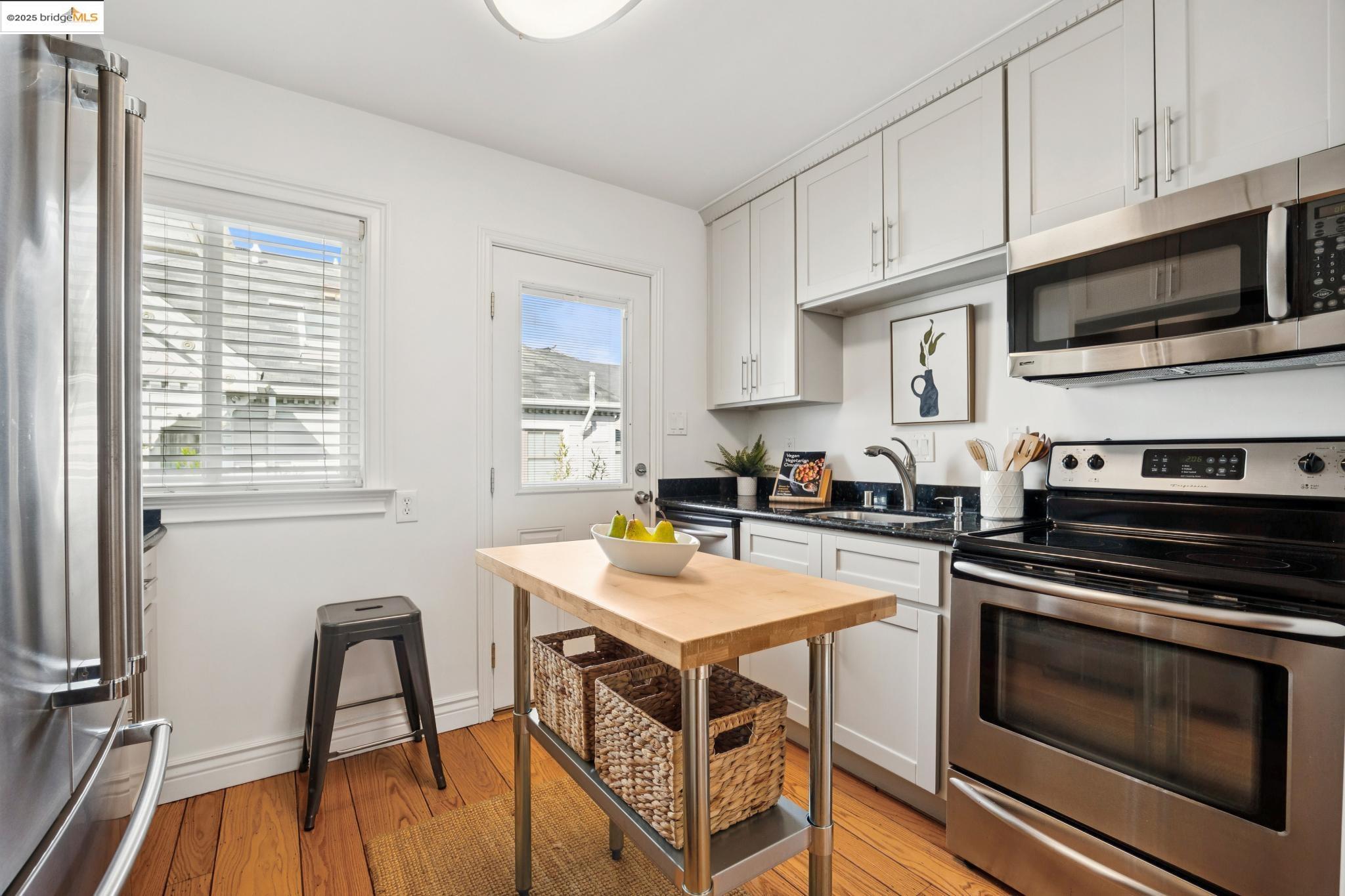 1609 Bonita Avenue, Unit 3 Berkeley, CA 94709 - Photo 3 of 10 a kitchen with a stove a sink and a microwave