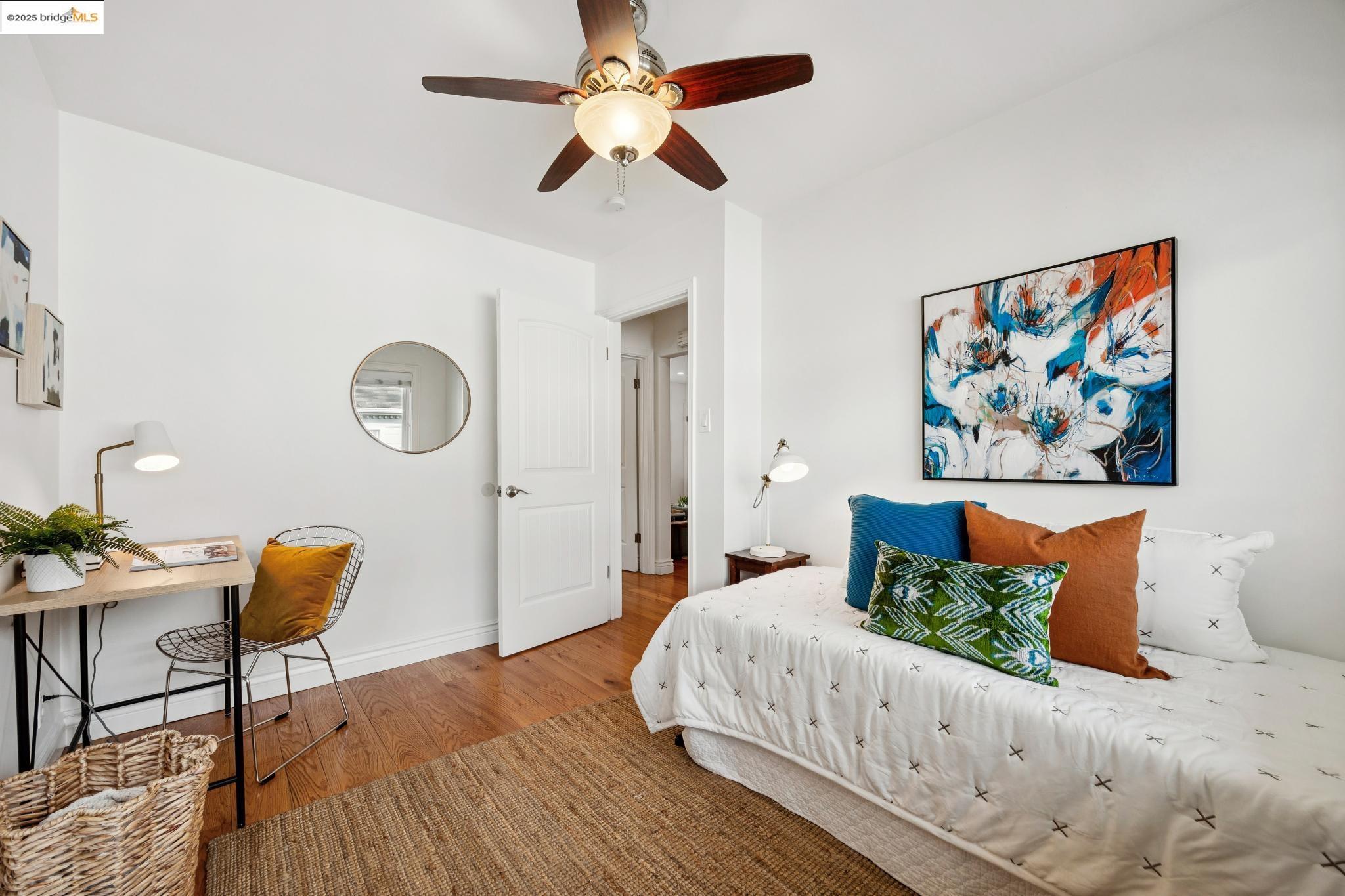 1609 Bonita Avenue, Unit 3 Berkeley, CA 94709 - Photo 8 of 10 a bedroom with a bed and a chandelier