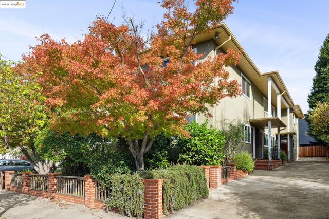 a view of a house with a tree in the background