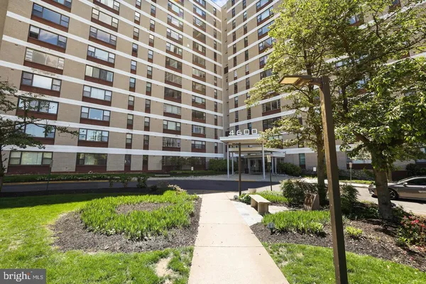 a view of tall brick building with a yard