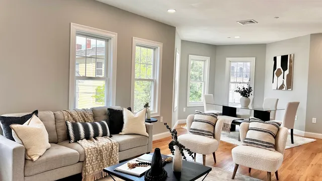 a living room with furniture and large windows