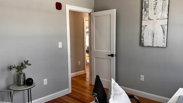 a view of a room with wooden floor and furniture