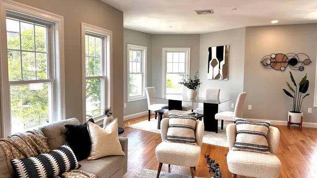 a living room with furniture and floor to ceiling windows