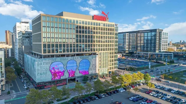 a view of a building with cars parked