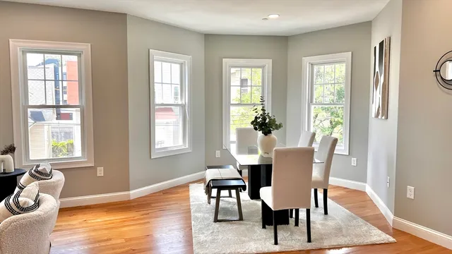 a view of a dining room with furniture window and wooden floor