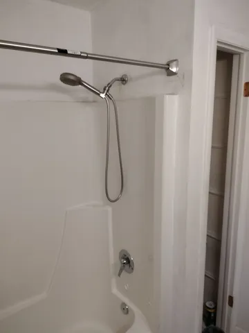 a bathroom with a shower and a shower