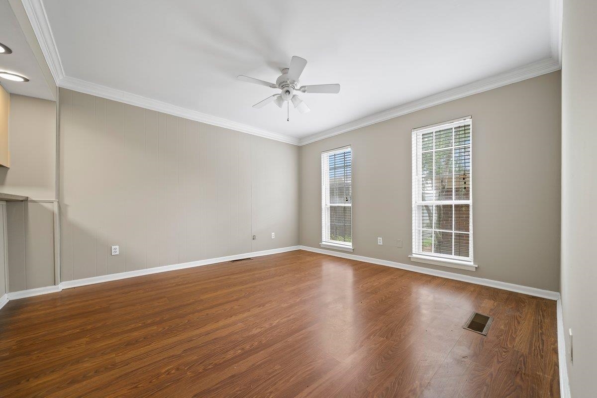 6942 Amberly Road, Unit 6942 Memphis, TN 38119 - Photo 9 of 23 wooden floor in an empty room with a window