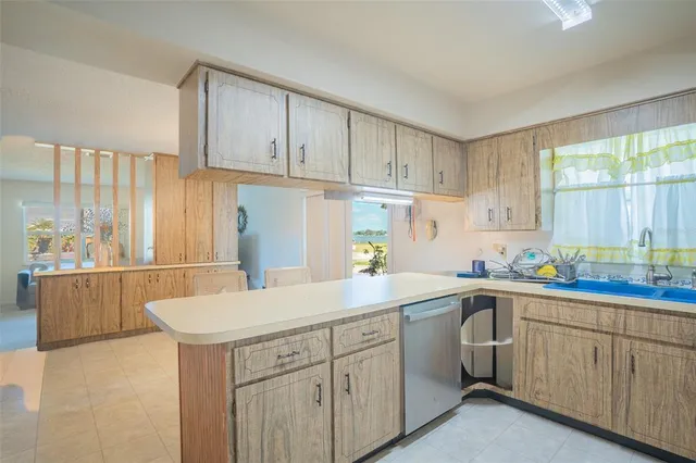 a kitchen with cabinets and refrigerator
