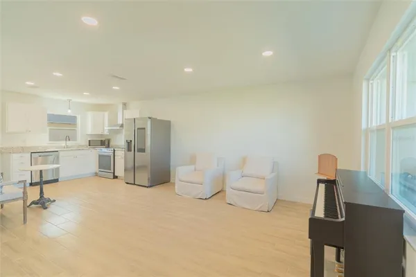a large white kitchen with white cabinets