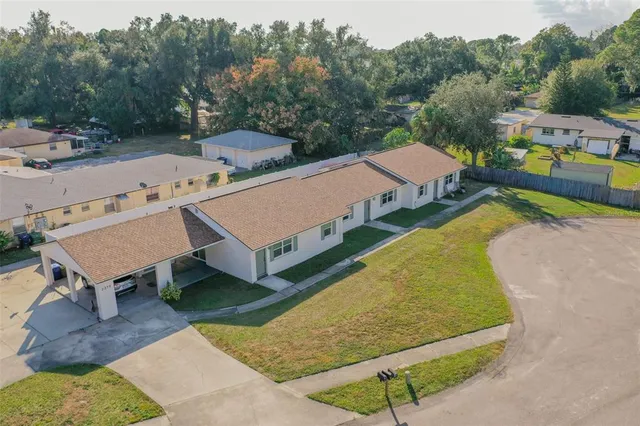 an aerial view of a swimming pool with outdoor seating