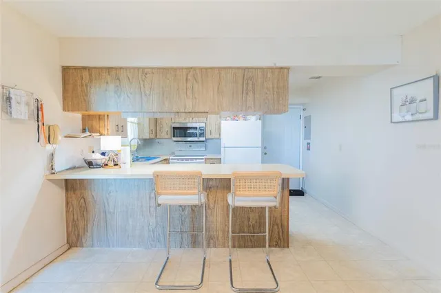 a refrigerator freezer sitting inside of a kitchen