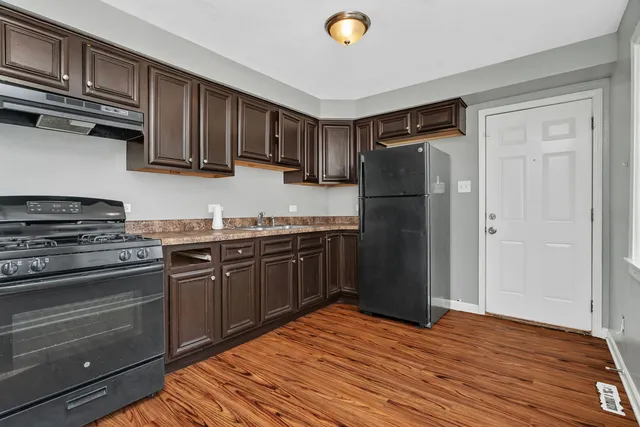 a kitchen with stainless steel appliances granite countertop a refrigerator stove and sink