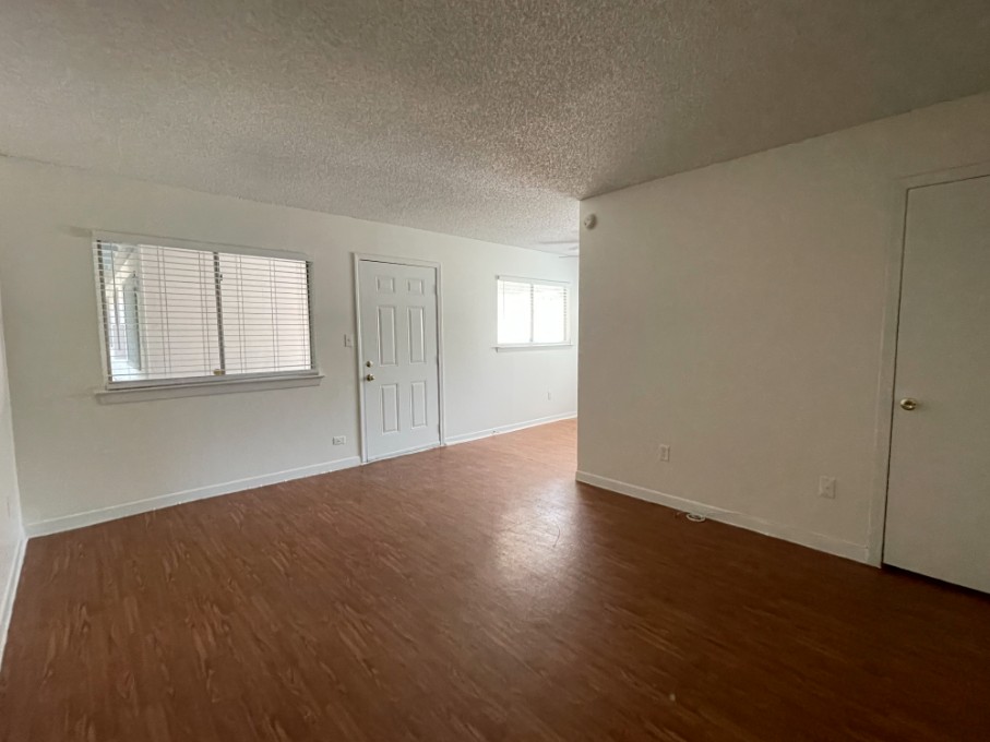 3106 Duval Street, Unit 203 Austin, TX 78705 - Photo 11 of 24 an empty room with wooden floor and windows