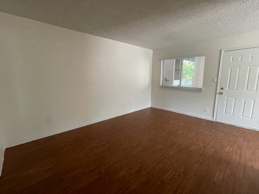 3106 Duval Street, Unit 203 Austin, TX 78705 - Photo 12 of 24 an empty room with wooden floor and windows
