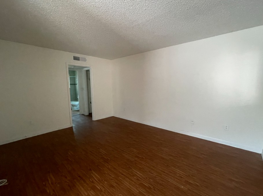 3106 Duval Street, Unit 203 Austin, TX 78705 - Photo 13 of 24 a view of an empty room with wooden floor and a window