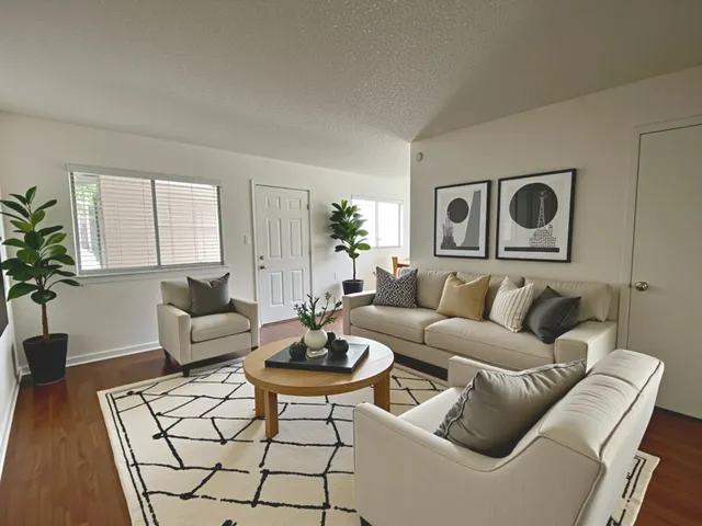 a living room with furniture and wooden floor