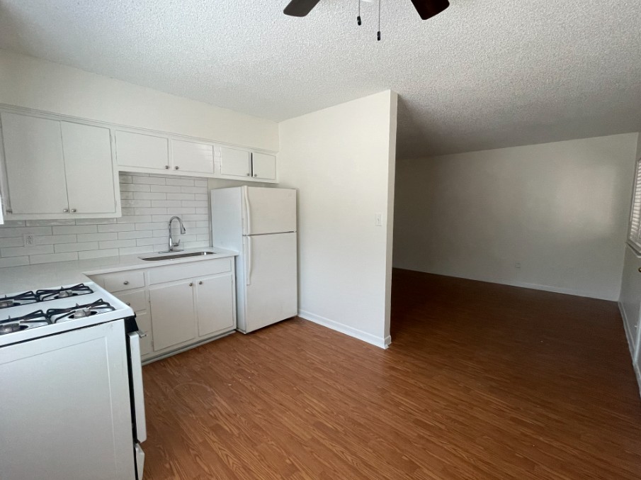 3106 Duval Street, Unit 203 Austin, TX 78705 - Photo 10 of 24 a kitchen with a refrigerator and a stove top oven