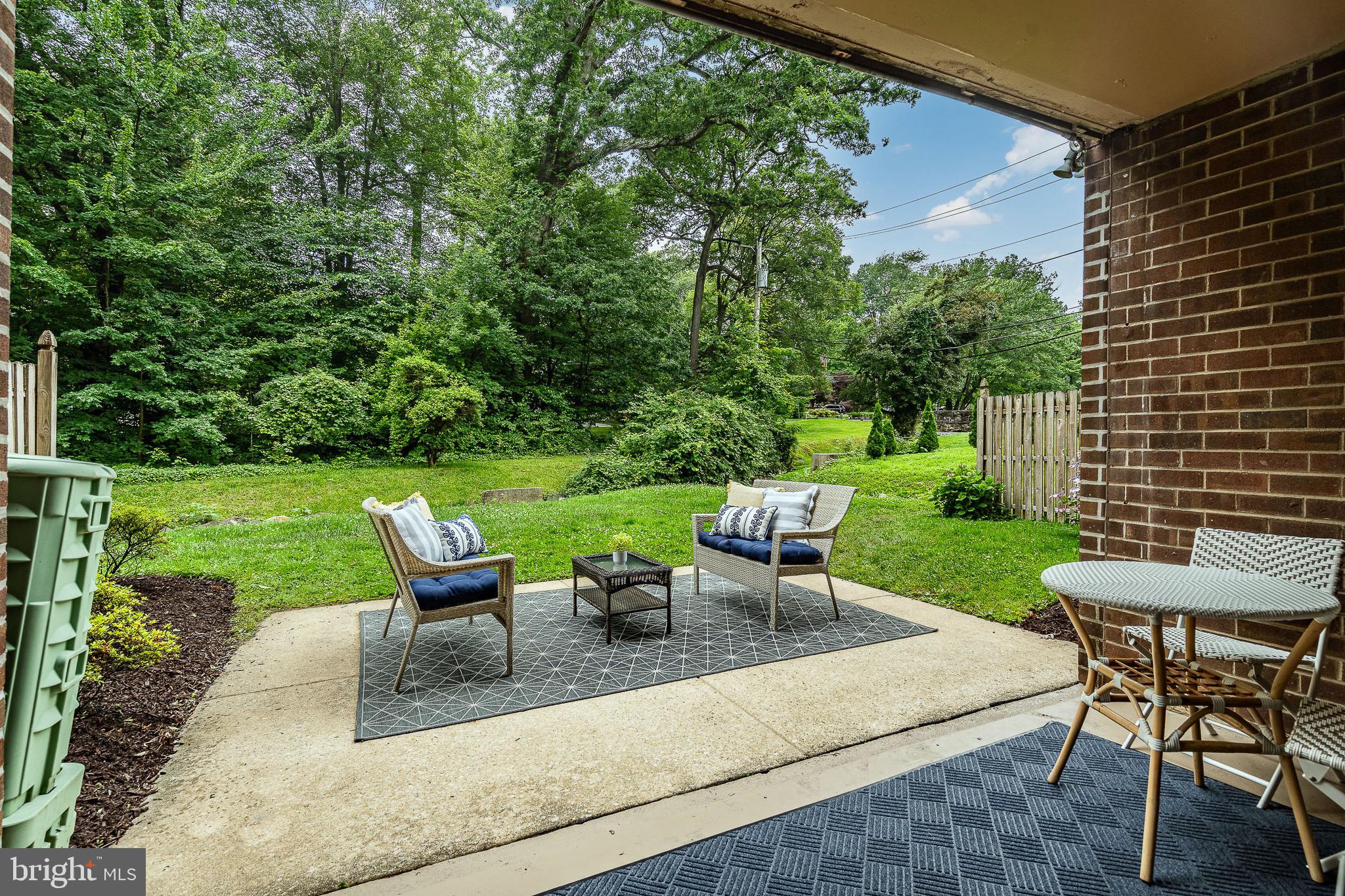 1219 West Wynnewood Road, Unit 105 Wynnewood, PA 19096 - Photo 22 of 34 a view of a patio with a table chairs and a backyard