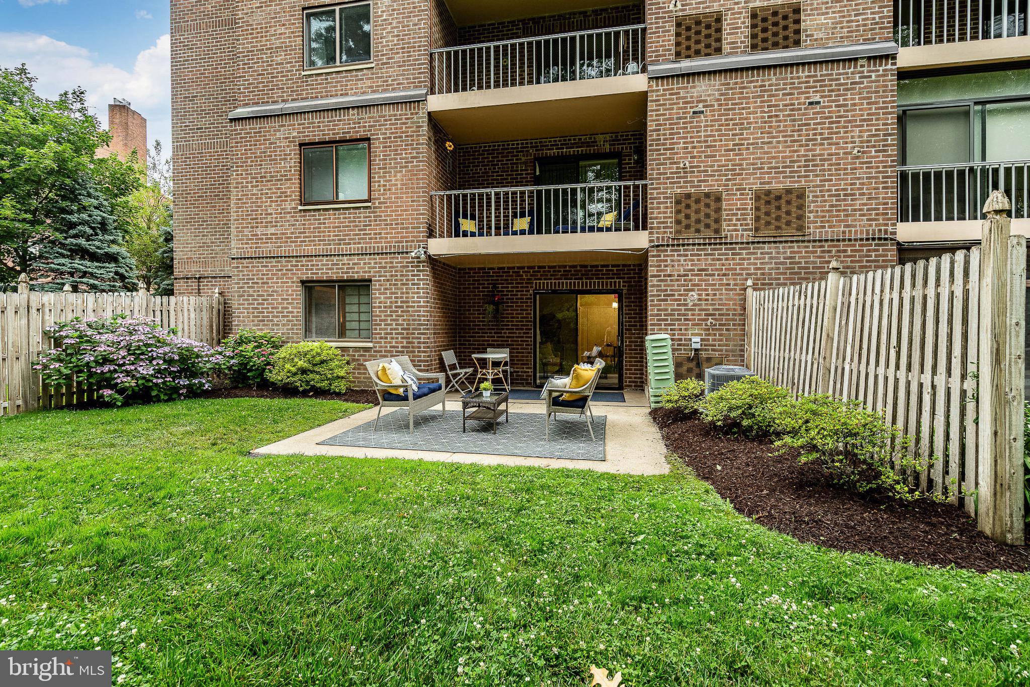 1219 West Wynnewood Road, Unit 105 Wynnewood, PA 19096 - Photo 25 of 34 a view of backyard of house with outdoor seating and green space