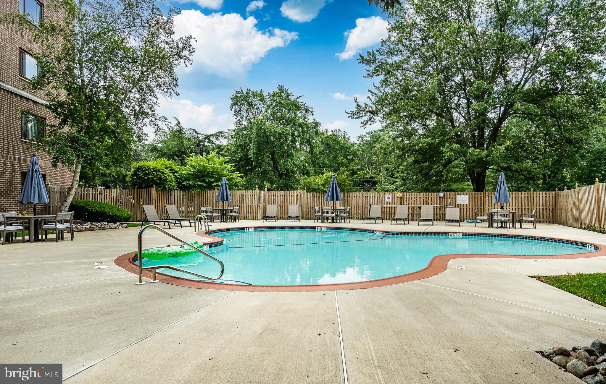1219 West Wynnewood Road, Unit 105 Wynnewood, PA 19096 - Photo 26 of 34 a view of a swimming pool with a patio