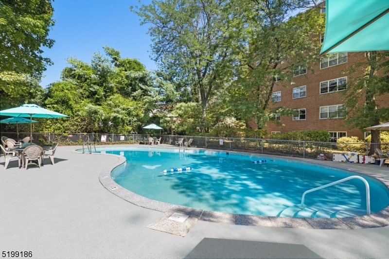 36 Hawthorne Place, Unit 2J Montclair, NJ 07042 - Photo 6 of 16 a swimming pool with outdoor seating and yard