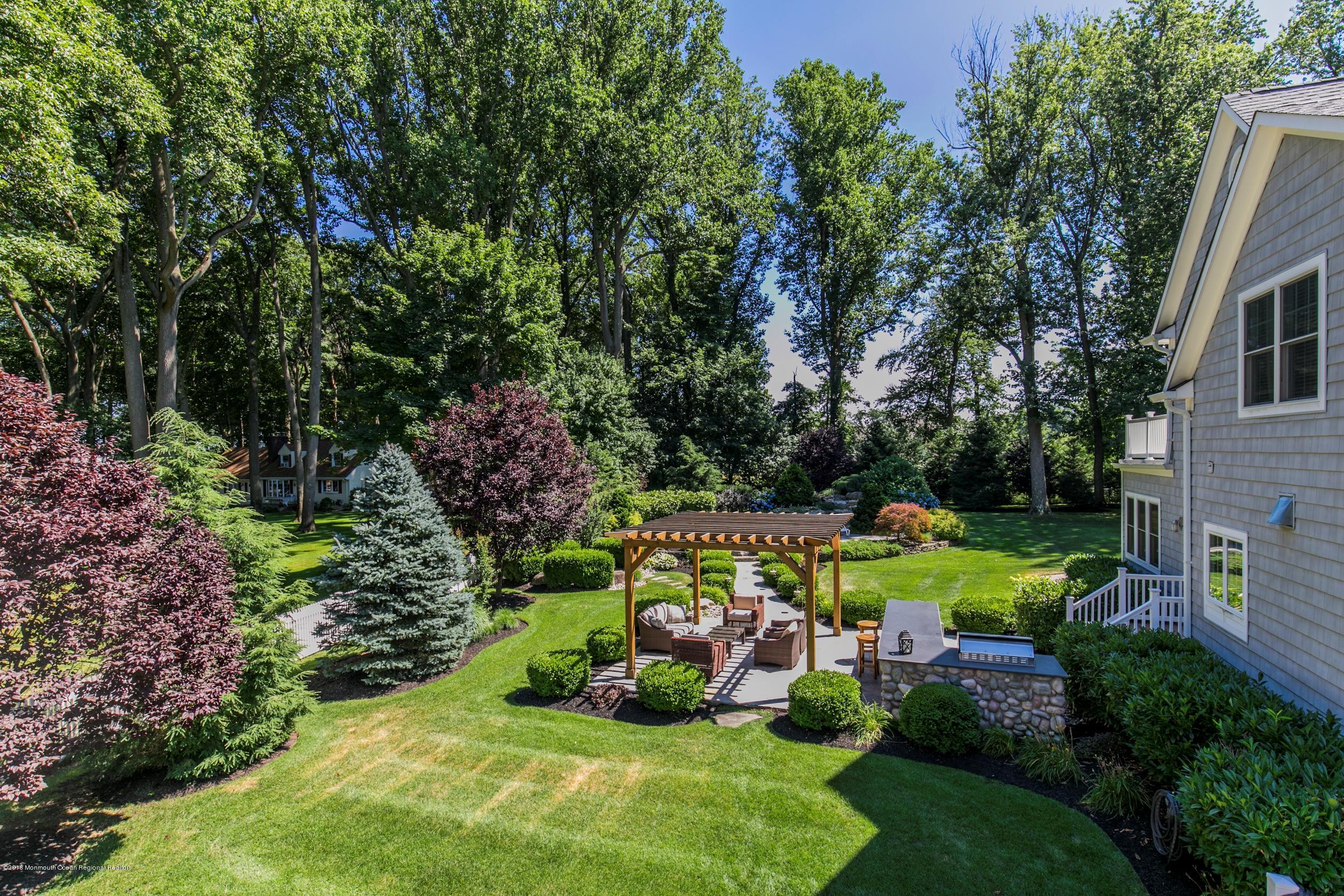 268 Sunnyside Road Lincroft, NJ 07738 - Photo 54 of 78 a view of a house with a yard and sitting area