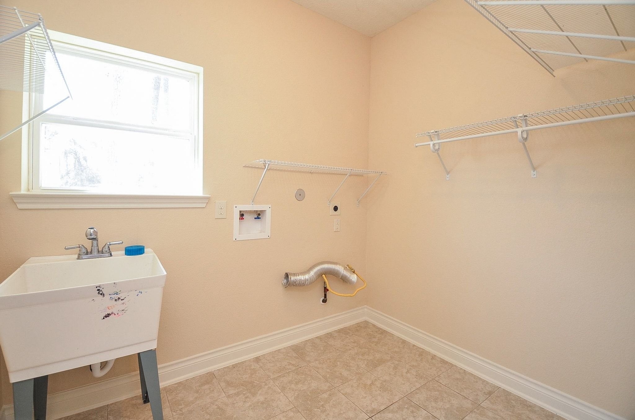 13327 Little Ranch Road Cypress, TX 77429 - Photo 22 of 49 a bathroom with a sink a toilet and a window