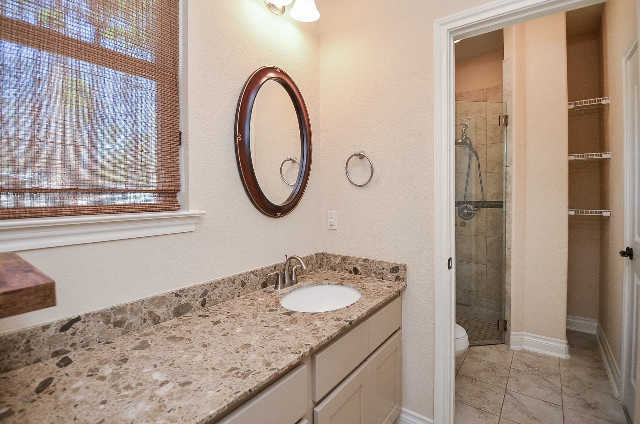 13327 Little Ranch Road Cypress, TX 77429 - Photo 28 of 49 a bathroom with a granite countertop sink and a mirror