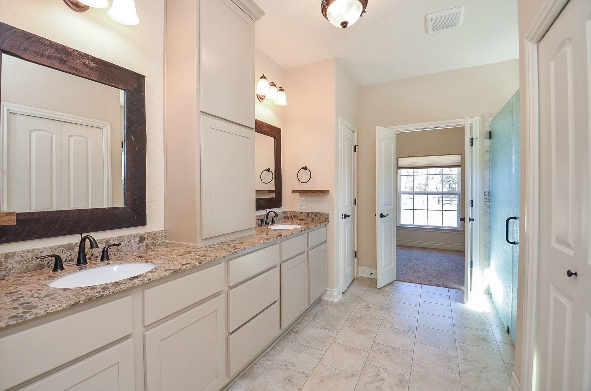 13327 Little Ranch Road Cypress, TX 77429 - Photo 34 of 49 a spacious bathroom with a granite countertop sink mirror and a