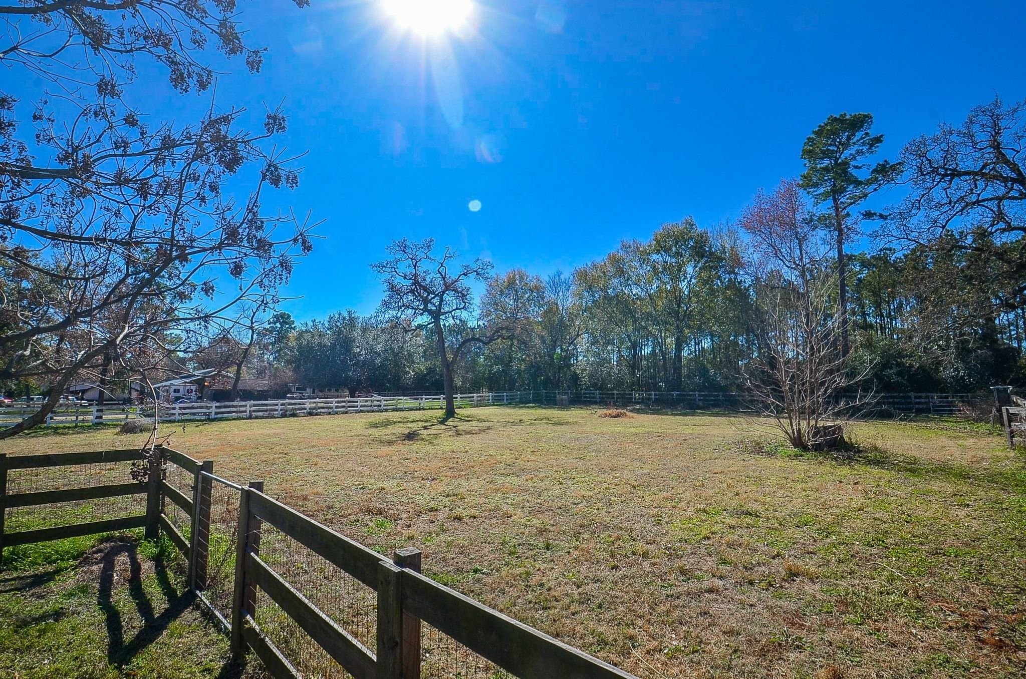 13327 Little Ranch Road Cypress, TX 77429 - Photo 40 of 49 Additional open land is located beyond the main living fence and is secured with double fencing for added separation and functionality. This expansive area offers versatile use, whether for animals, recreation, storage, or future improvements, all within a private, tree-lined setting.