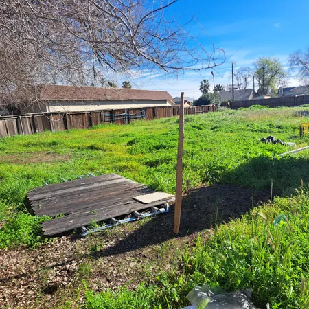 a view of house with backyard and outdoor seating