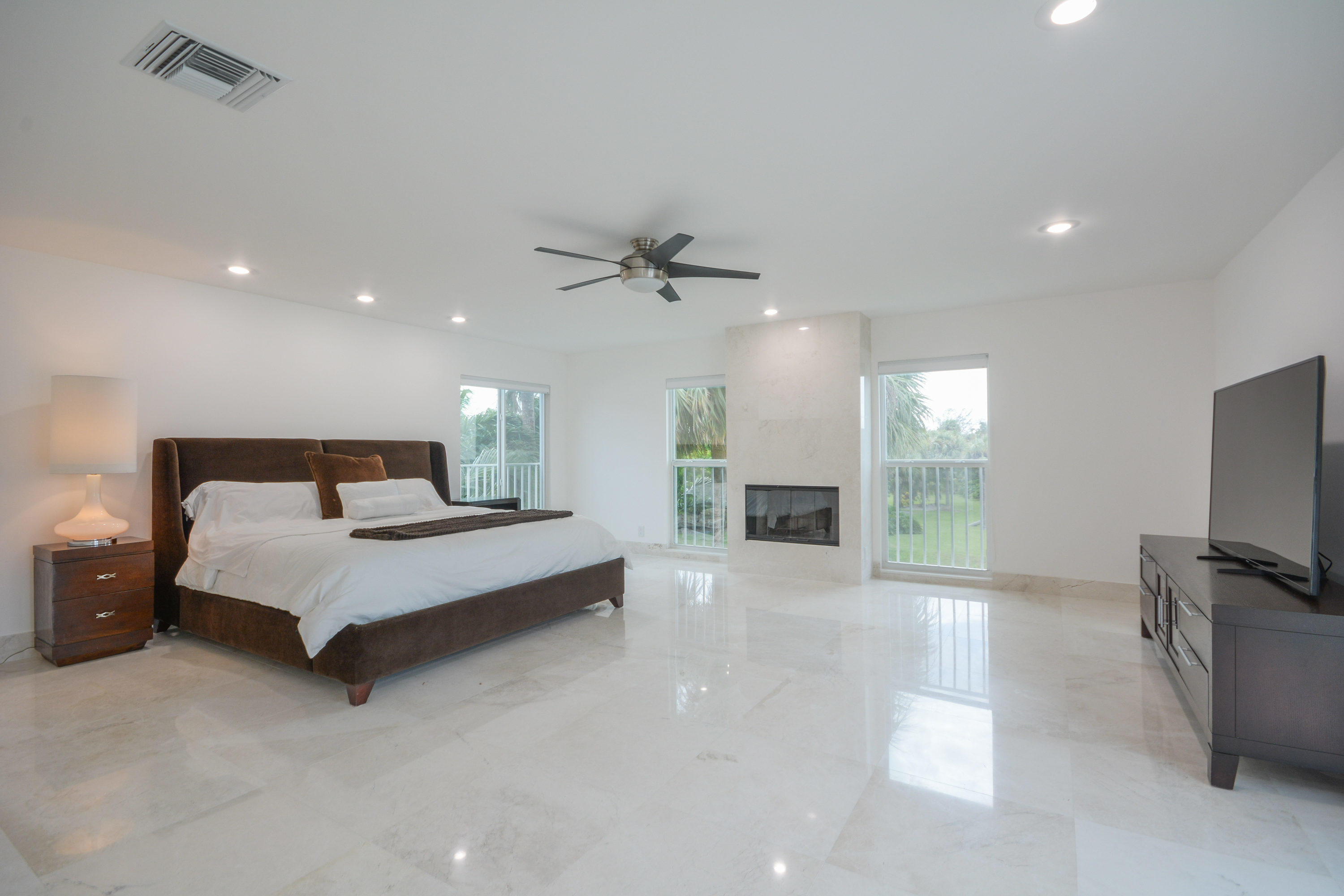 1041 Southwest 21st Avenue Boca Raton, FL 33486 - Photo 11 of 67 a spacious bedroom with a bed and glass door